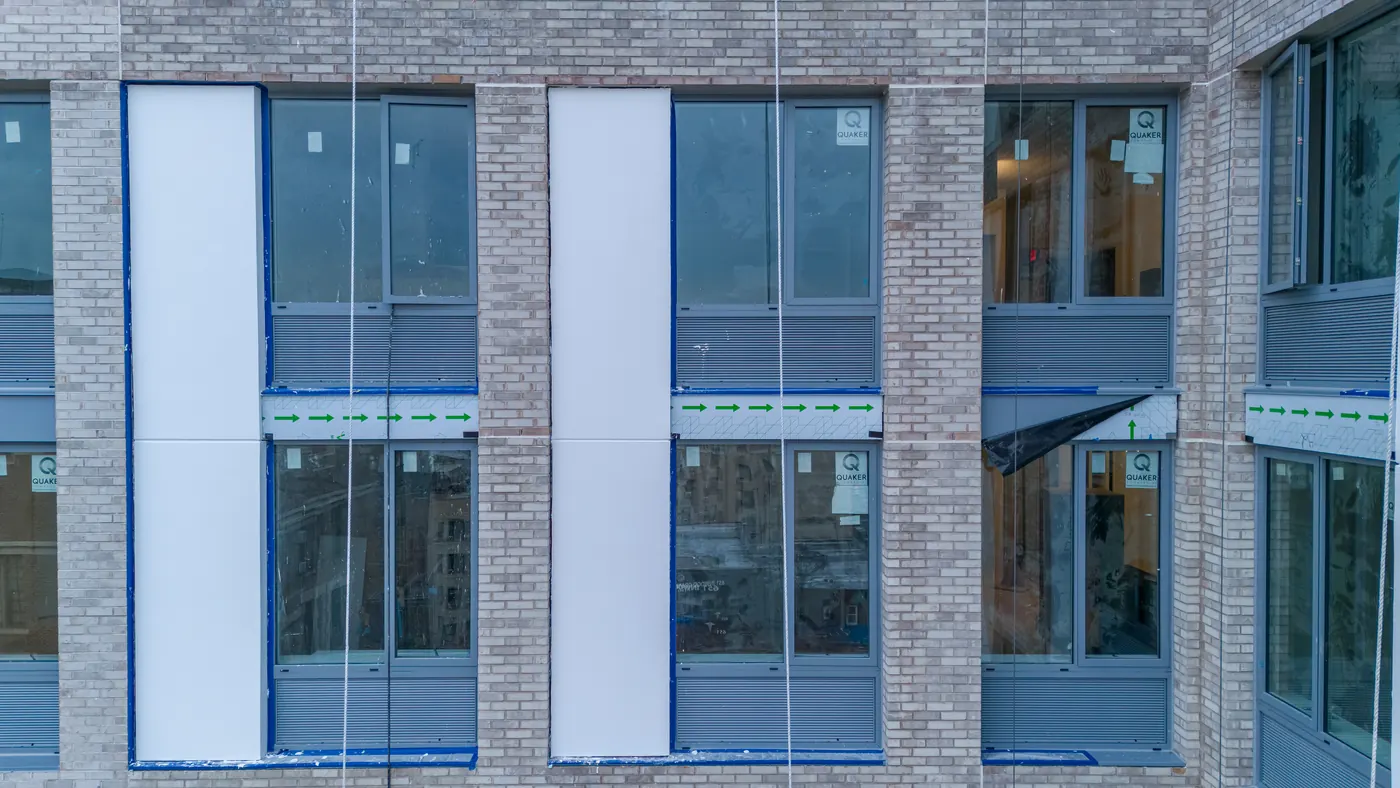 Window arrangement on the brick facade of The Eliza on Broadway in Inwood, Manhattan